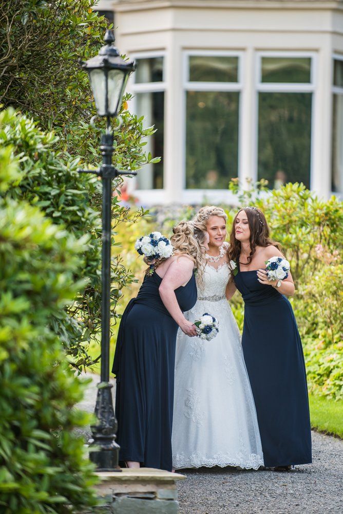 Bridesmaids final hug before walking up aisle, Inn on the Lake Weddings, Lake District