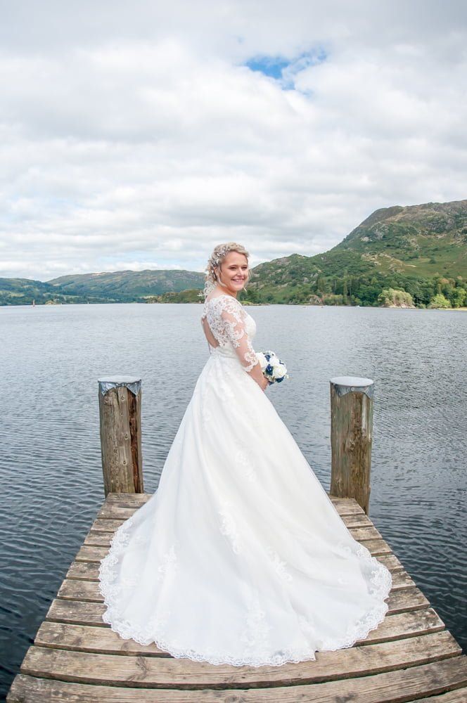 Bride and dress on jetty, Inn on the Lake Weddings, Lake District