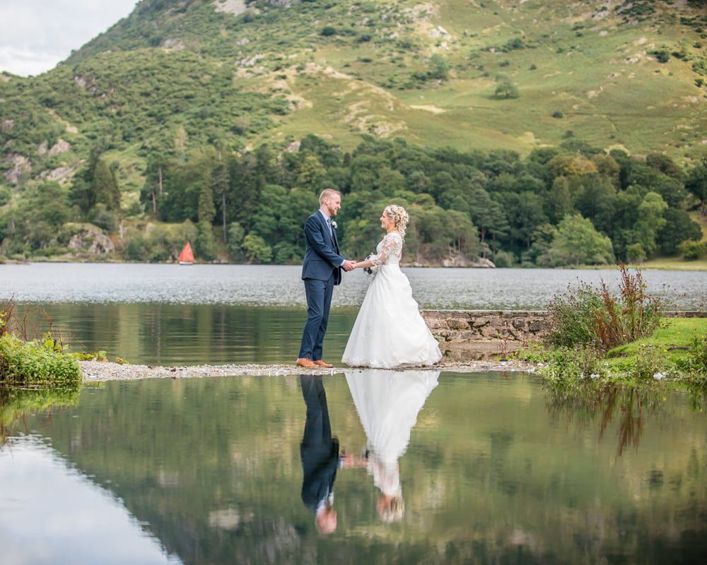 Holding hands on mirror lake, Inn on the Lake Weddings, Lake District