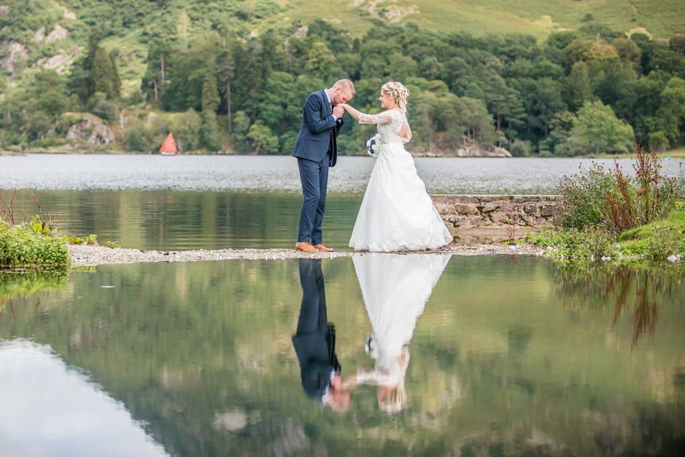 Kissing brides hands, Inn on the Lake Weddings, Lake District