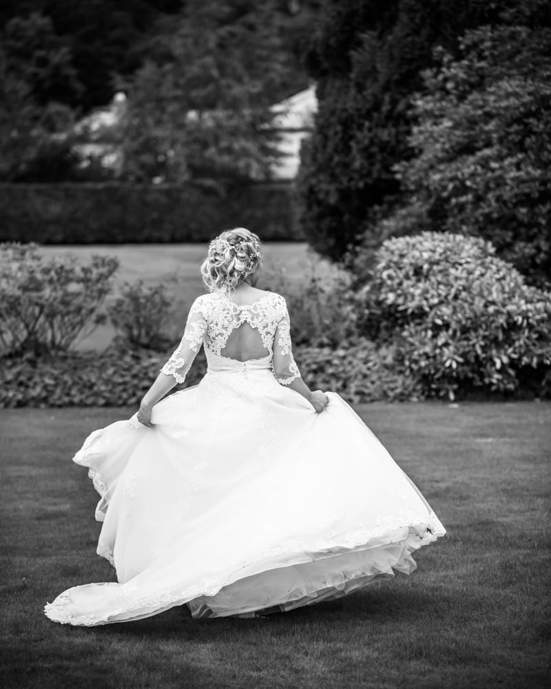Bride swishing dress around, Inn on the Lake Weddings, Lake District