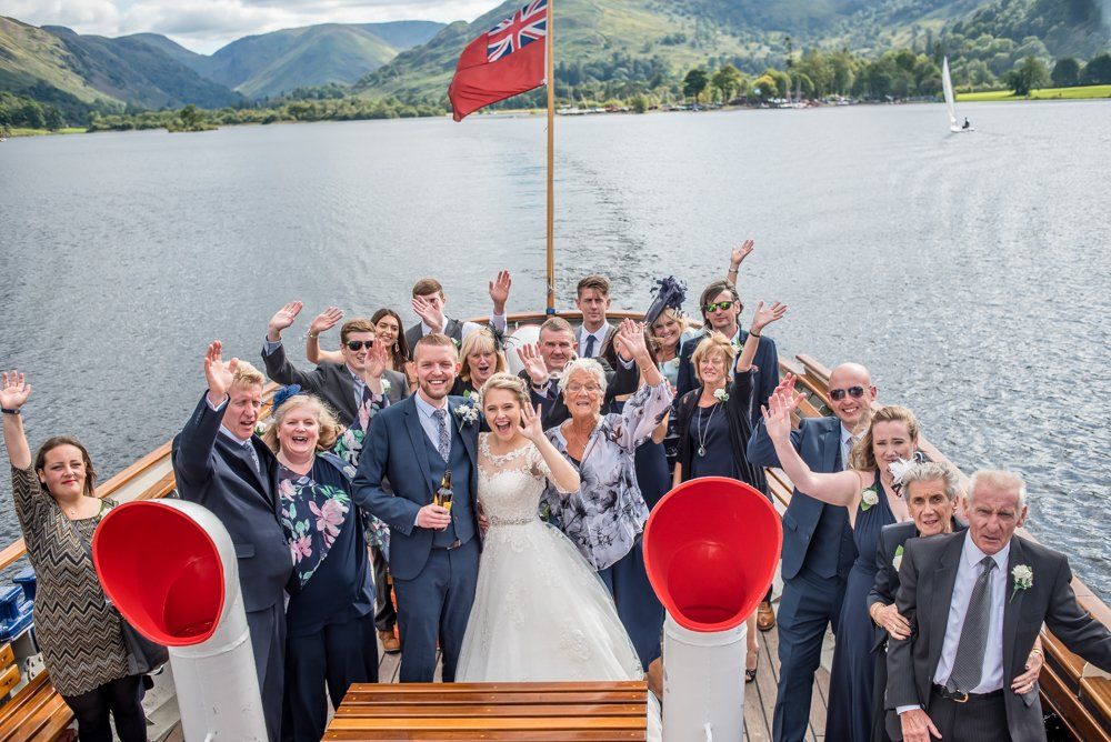 Wedding party waving on steamer, Inn on the Lake Weddings, Lake District