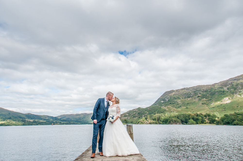 Bride and groom kissing, Inn on the Lake, Ullswater, Lake District documentary wedding photographers