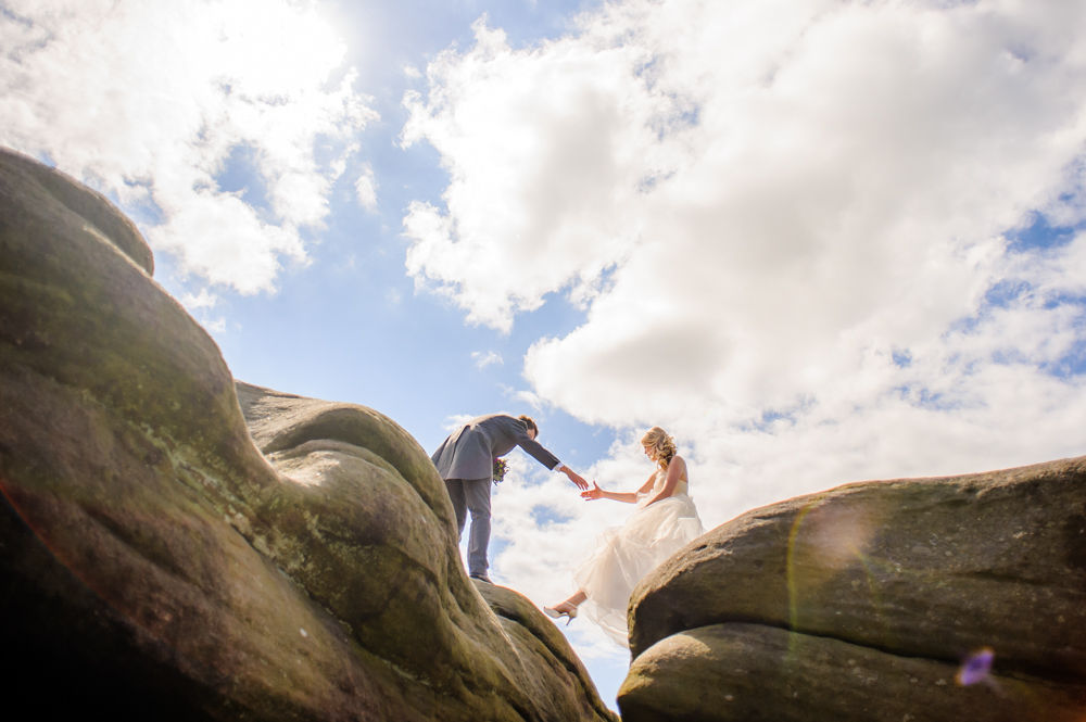 Emma & Nick holding hands on rocks, Surprise View, Peak District wedding photographers Sheffield