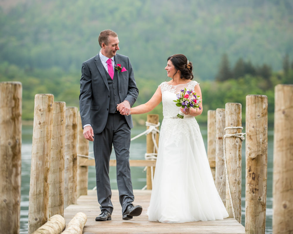 Gill and Monty walking on jetty at Lingholm Estate, Lake District wedding photographers
