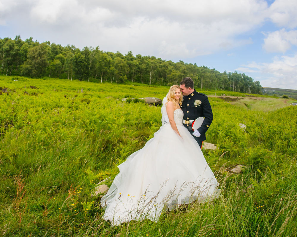 Lucy & Tom posing in grass at Surprise View, Peak District wedding photographers Sheffield