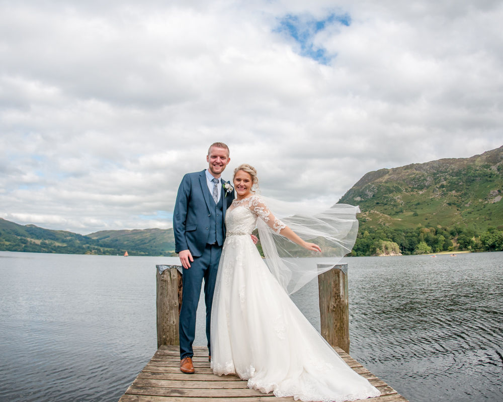 Sarah and Joshua on jetty at Inn on the Lake, Lake District wedding photography