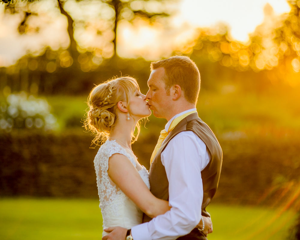 Verity and Adam kissing at sunset, Smallshaw Farm Cottages weddings, Sheffield wedding photography