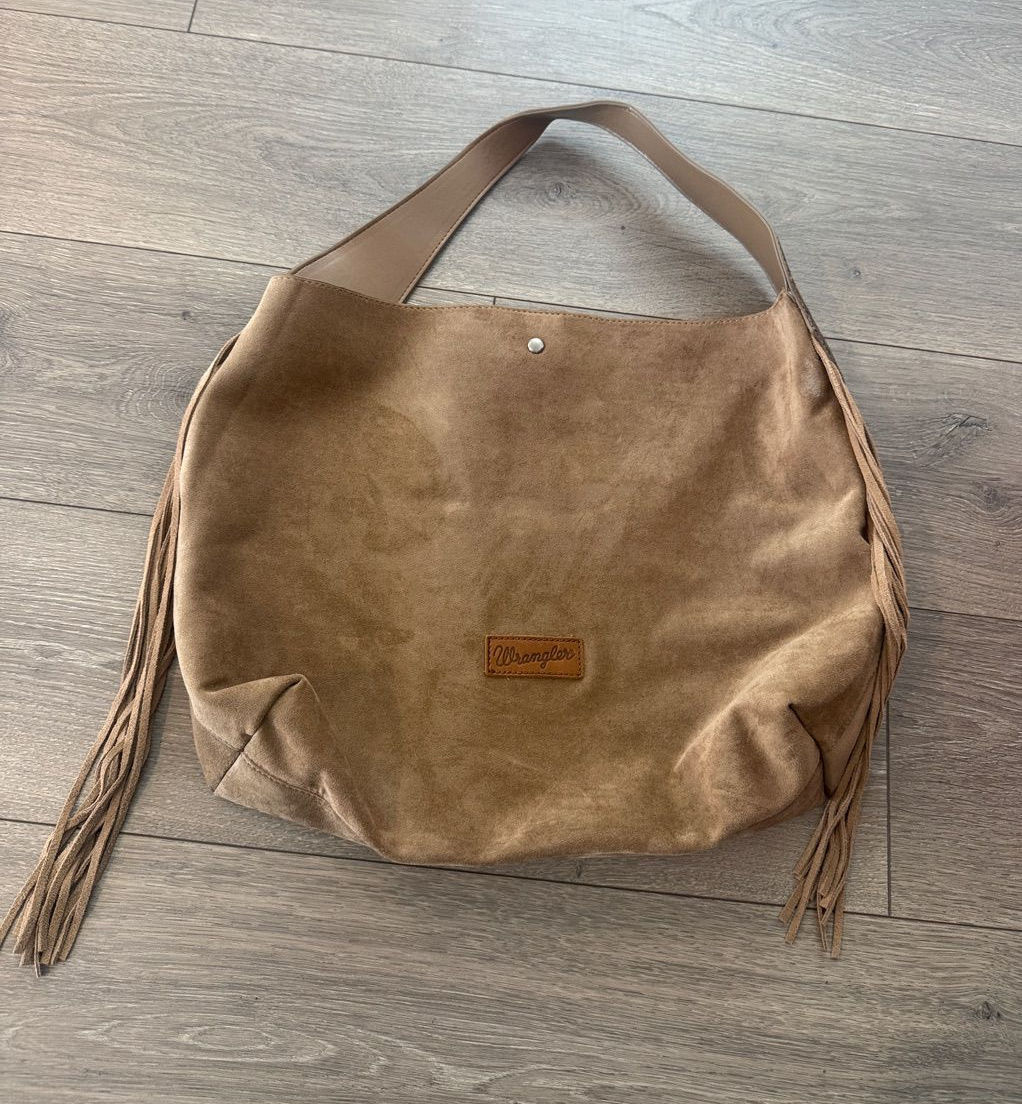 Tan suede shoulder bag with long fringe strands and a visible shoulder strap.