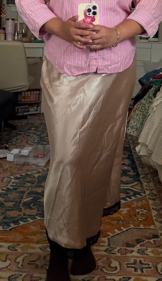 Cream satin maxi skirt with contrasting black lace at the hem.