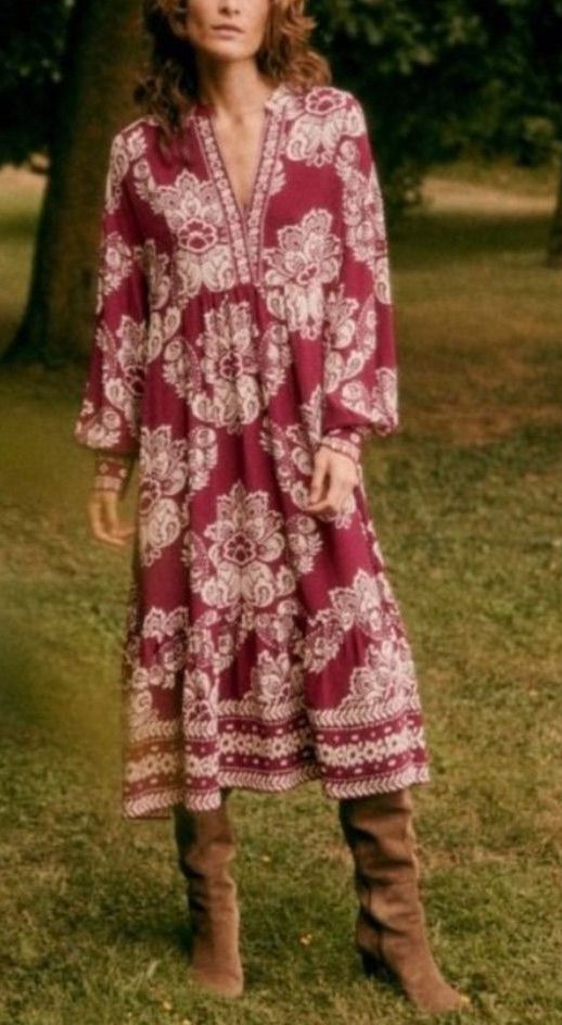 Burgundy floral midi dress styled with tall brown boots.