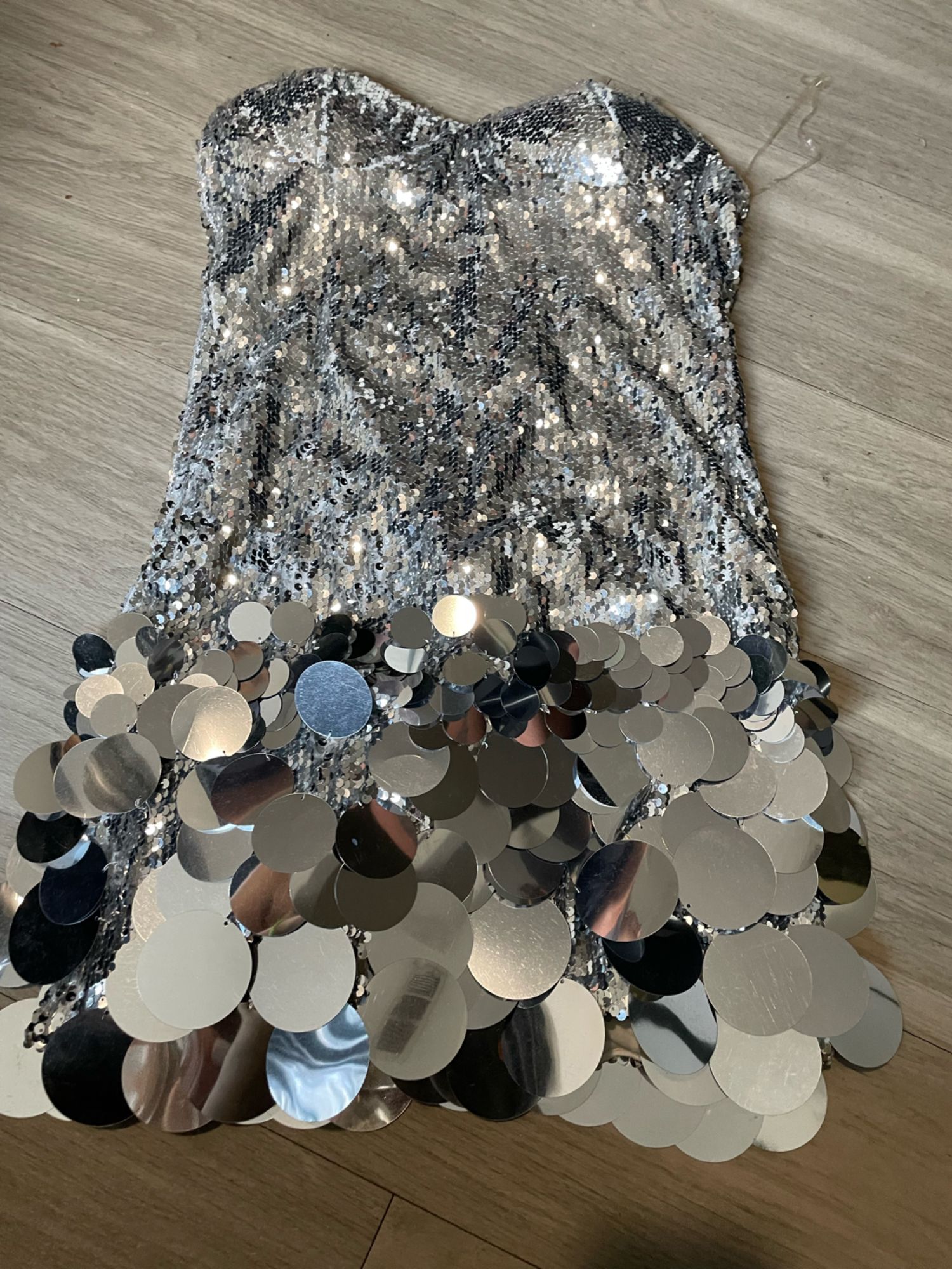 Silver sequin mini dress with oversized paillettes and a bubble hem.