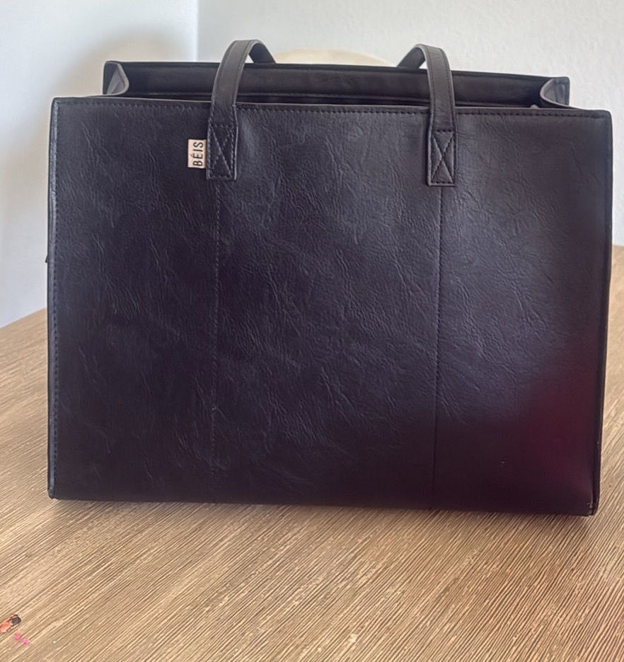 Black structured BEIS work tote with sturdy handles and a zip-top silhouette.