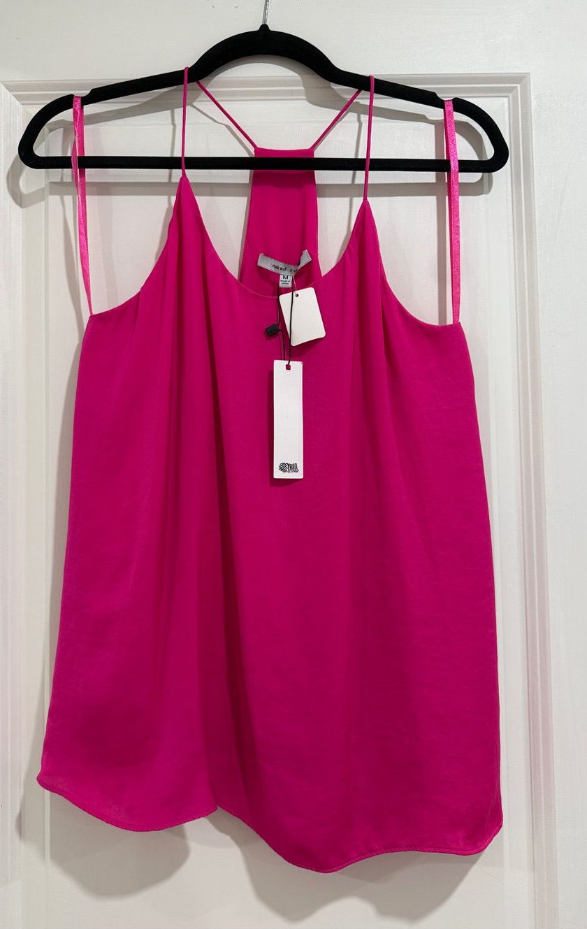 Hot-pink camisole with thin straps and a flowing silhouette on a hanger.