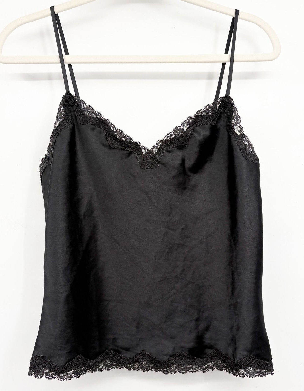 Black satin Y2K camisole with a delicate lace-trimmed neckline and hem.