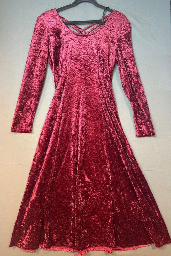 Burgundy crushed-velvet maxi dress with a lace-up neckline and light-catching texture.