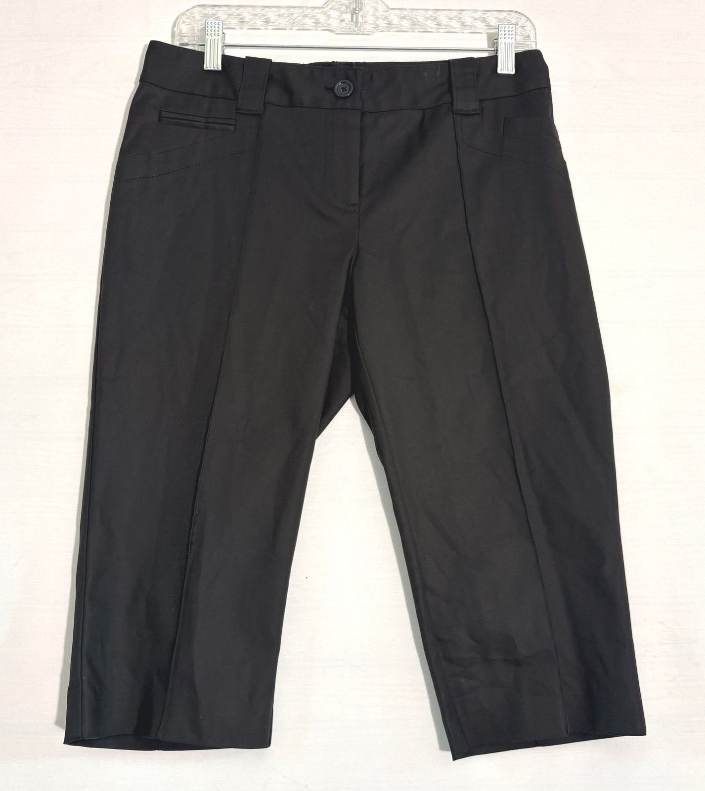Black tailored capri trousers with a simple waistband, visible seams, and straight cropped legs.