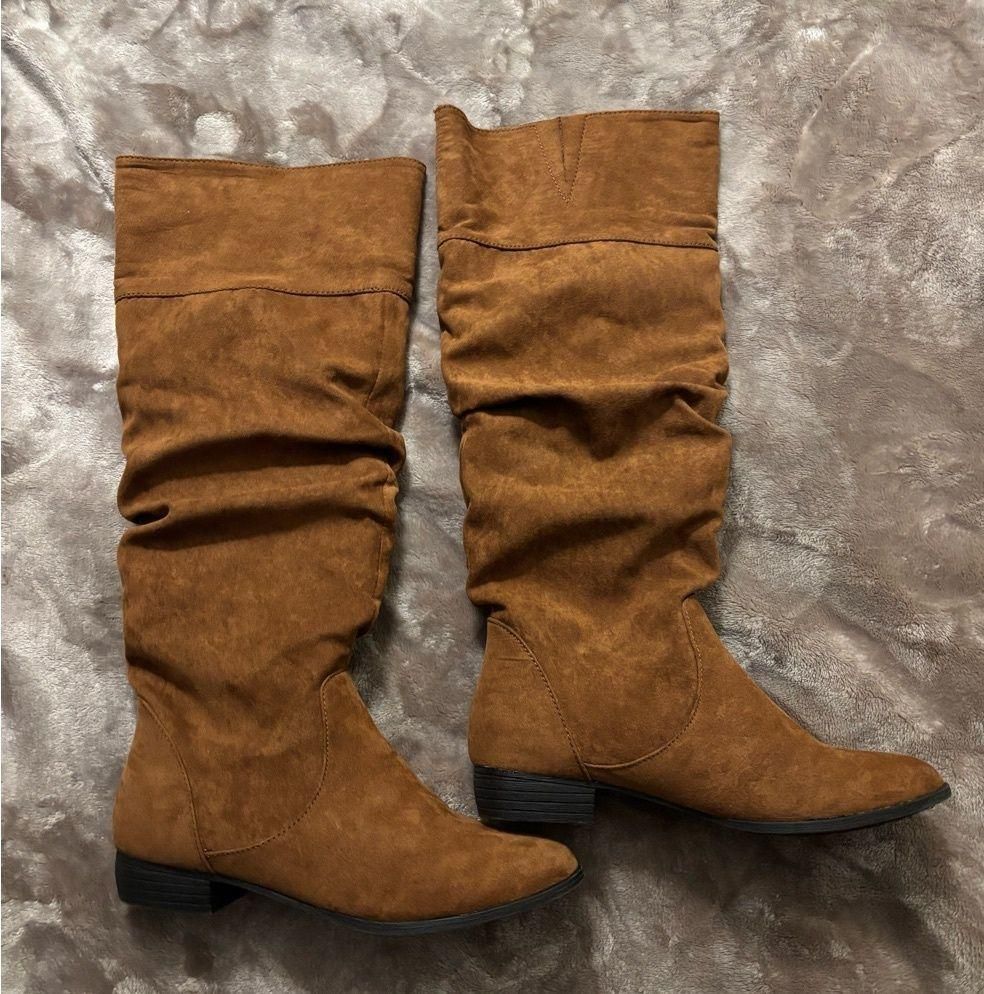 Chestnut faux-suede knee-high slouch boots with pronounced relaxed folds through the shafts.