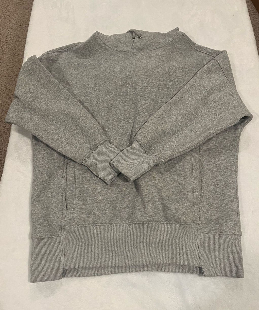 Heather gray fleece pullover hoodie with a roomy hood, relaxed fit, kangaroo pocket, and ribbed cuffs.