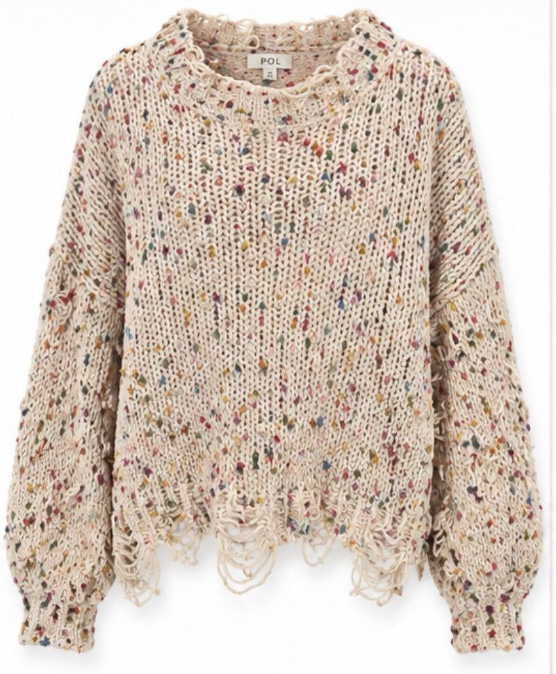 Cream confetti-knit sweater with deliberately unraveled fringe at the hem and sleeves.