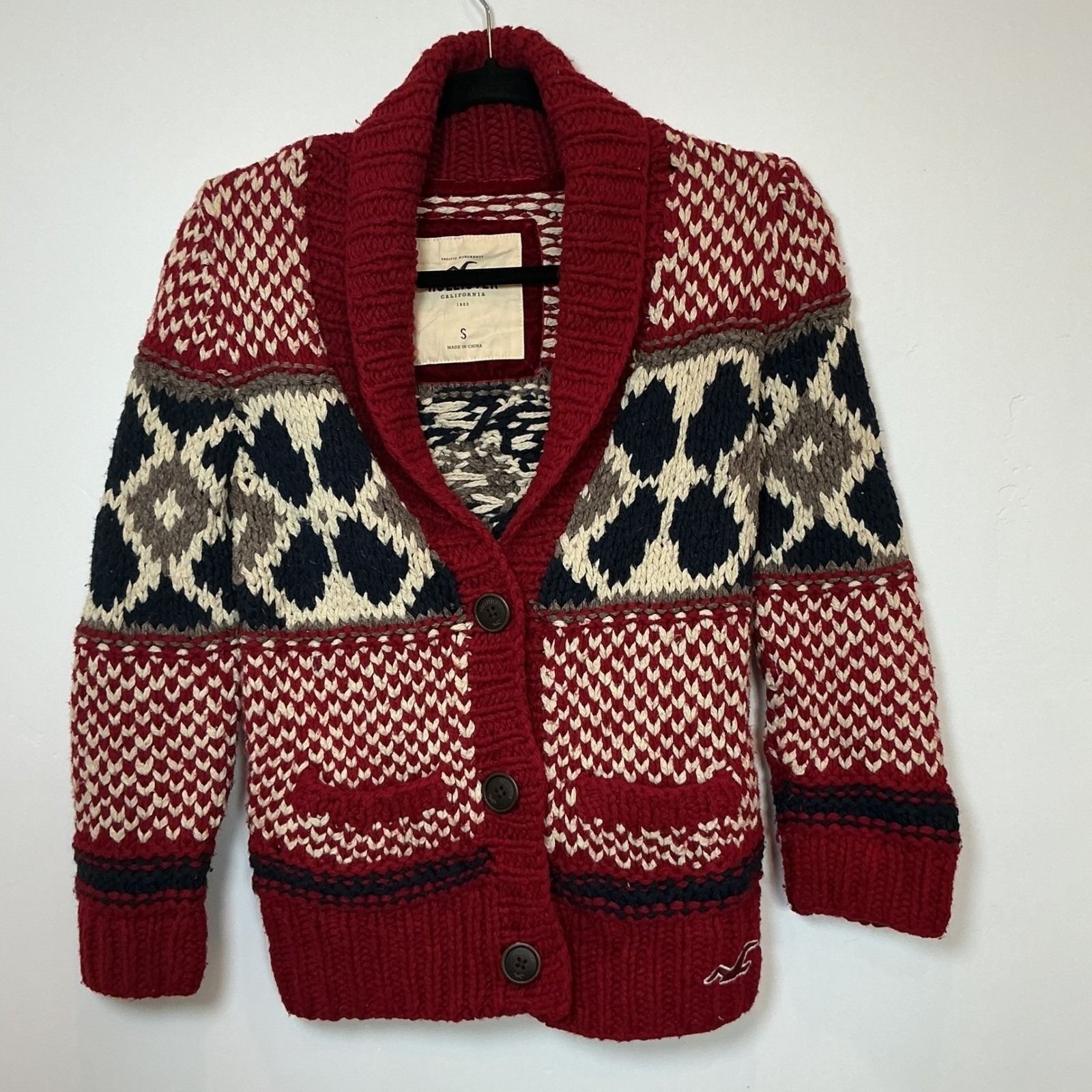 Red, cream, navy, and tan Fair Isle cardigan with a chunky shawl collar.