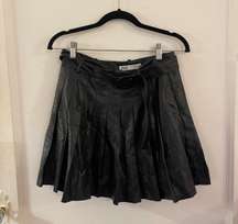 Pleated faux leather skirt with a belt