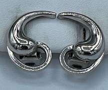 Vintage “Alice” silver tone swirl clip earrings.