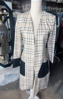 $159  checkered long Cardigan cream jacket leather pockets long sleeve leather cuff adjustable waist tie padded shoulder size 4 NWT New with tag  Same day shipping Smoke and pets free  Elevate your winter wardrobe with this stunning  checkered cardigan jacket. Crafted with high-quality polyester, this long overcoat comes with leather pockets for added convenience. The jacket boasts a unique check pattern that is sure to turn heads wherever you go.  This padded jacket is perfect for cold winter nights and comes with a strap accent that adds a touch of sophistication to the overall design. Available in size 4, this jacket is perfect for women who prefer a regular fit. Don't miss out on this must-have cold weather essential!