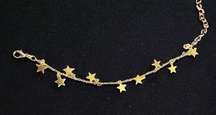 Gold bracelet with small gold star charms