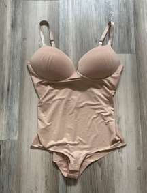 Assets Size Large, nude in color, built in convertible bra adjustable straps, pit to pit is 5, length from top to bottom is 19