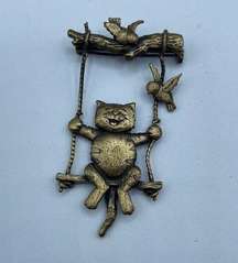 Vintage JJ Kitty swinging with birdies. This is brass and it does swing.