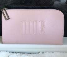 Make up bag in light pink, zipper pull has the D logo