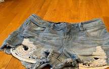 Harper High Waisted denim shorts with embroidered pockets, size 27.