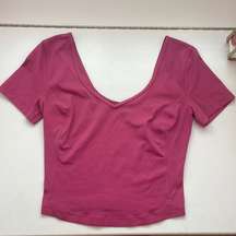 This  align t-shirt is in a size 2 and is a dark pink magenta color.