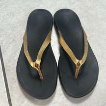 OluKai Ho'Opio Womens Gold Black Slip On Thong Sandals