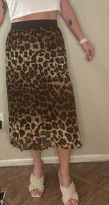 Sheer, accordion, mid calf length, leopard print skirt, size Large.