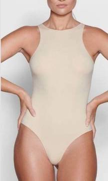 Canvas body suit. Essential wardrobe foundation. Snaps at crotch. Beige