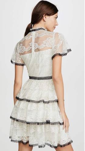 Shoshanna Stacia Lace Tiered Polka Dot Knee Length High Neck Black trim on neck/sleeve/bottom Hidden back zipper A flutter sleeve ballet lace fit-and-flare mini dress with ruffle detail below the waist ivory cream Kentucky Derby mock sheer layer