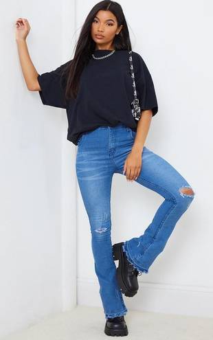 Pretty Little Thing Mid Blue Distressed Knee Flare Jean