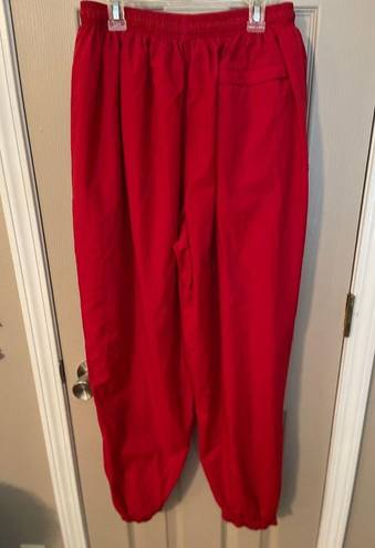 Russell Athletic Russell women’s vintage red lined nylon track pants w/pocket zip ankles. Size L