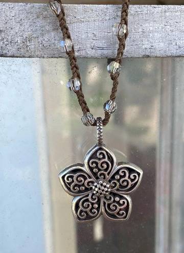 Brighton  Silver Toned Flower Reversible Pendant on a Brown Braided Cord. EUC!