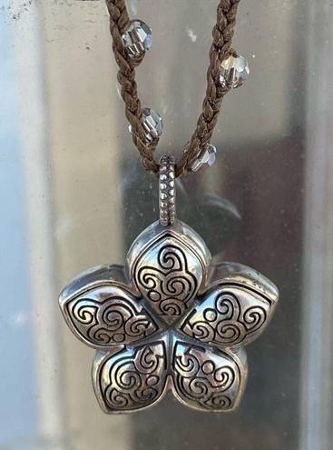 Brighton  Silver Toned Flower Reversible Pendant on a Brown Braided Cord. EUC!