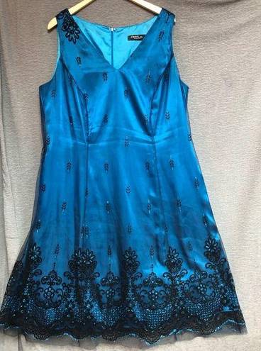 Onyx  night sleeveless teal satin dress with black mesh overlay, and black design