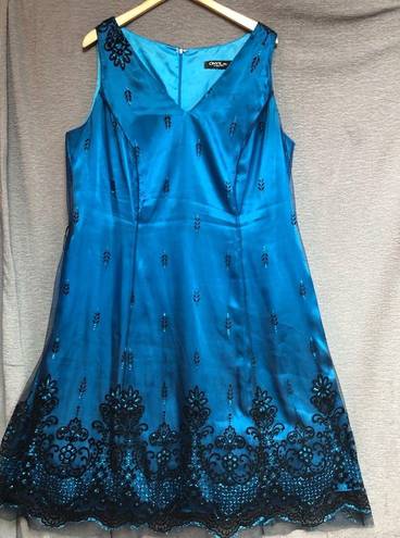 Onyx  night sleeveless teal satin dress with black mesh overlay, and black design