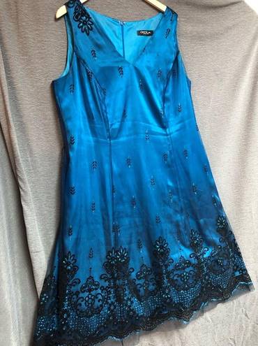 Onyx  night sleeveless teal satin dress with black mesh overlay, and black design