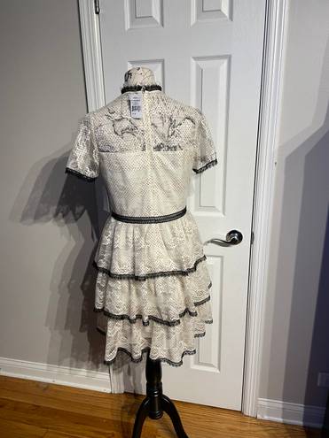 Shoshanna Stacia Lace Tiered Polka Dot Knee Length High Neck Black trim on neck/sleeve/bottom Hidden back zipper A flutter sleeve ballet lace fit-and-flare mini dress with ruffle detail below the waist ivory cream Kentucky Derby mock sheer layer