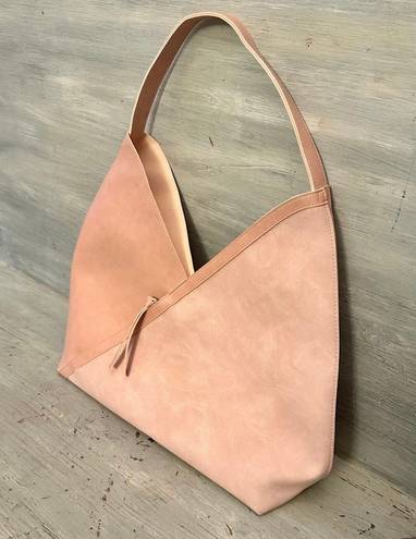 Hobo pink and tan shoulder bag with a unique asymmetrical design, featuring a side zipper closure