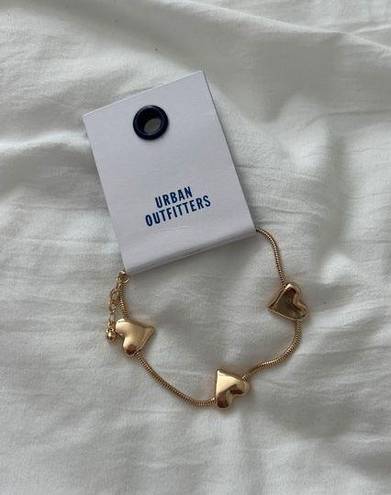 Urban Outfitters heart bracelet   One Size  Condition: NWT Color: gold