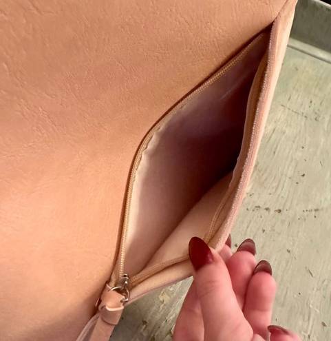 Hobo pink and tan shoulder bag with a unique asymmetrical design, featuring a side zipper closure