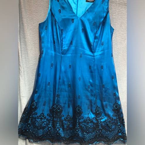 Onyx  night sleeveless teal satin dress with black mesh overlay, and black design